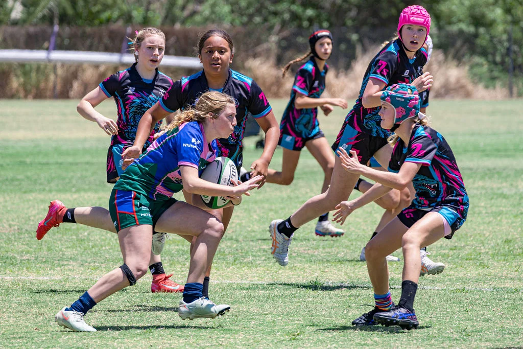Girls playing rugby at Viking Cup 2026 as the ball carrier approaches defenders